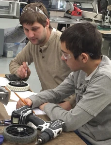 Mr. Congdon and Aiden looking at wheel options for the drive system