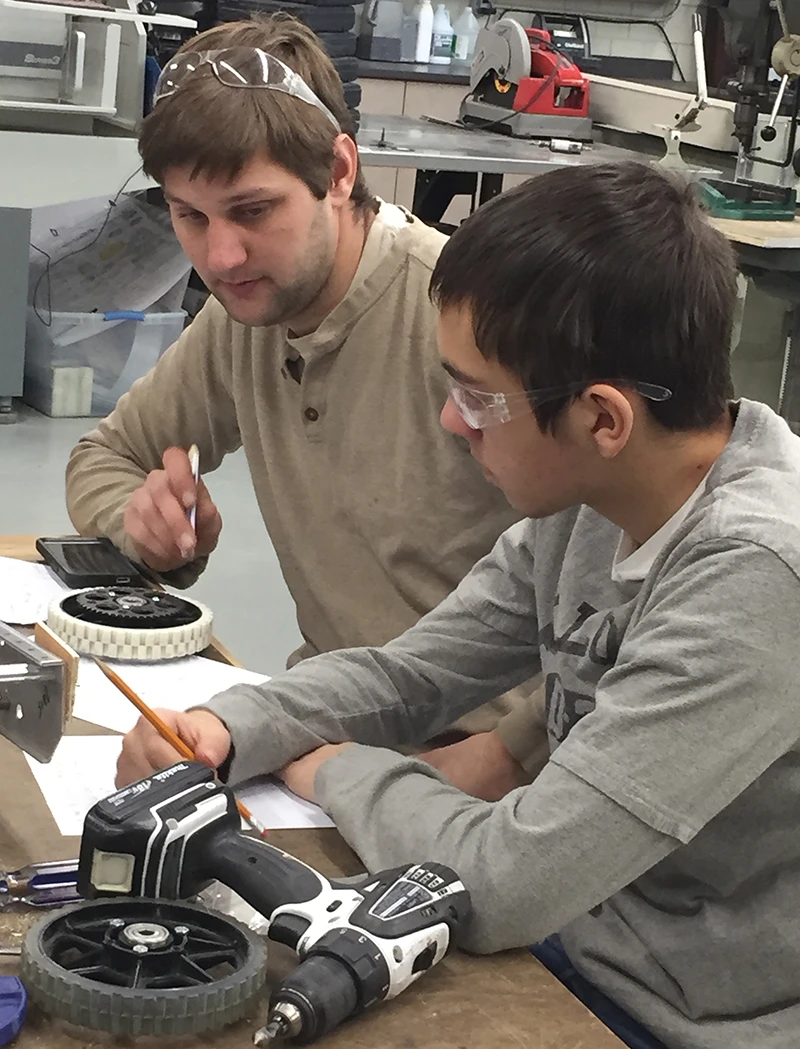 Mr. Congdon and Aiden looking at wheel options for the drive system