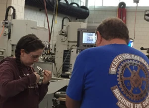 Mr. Petri helping Anna with a part
