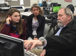Mr. Gentry showing Shannon & Sophie how to develop the parts list