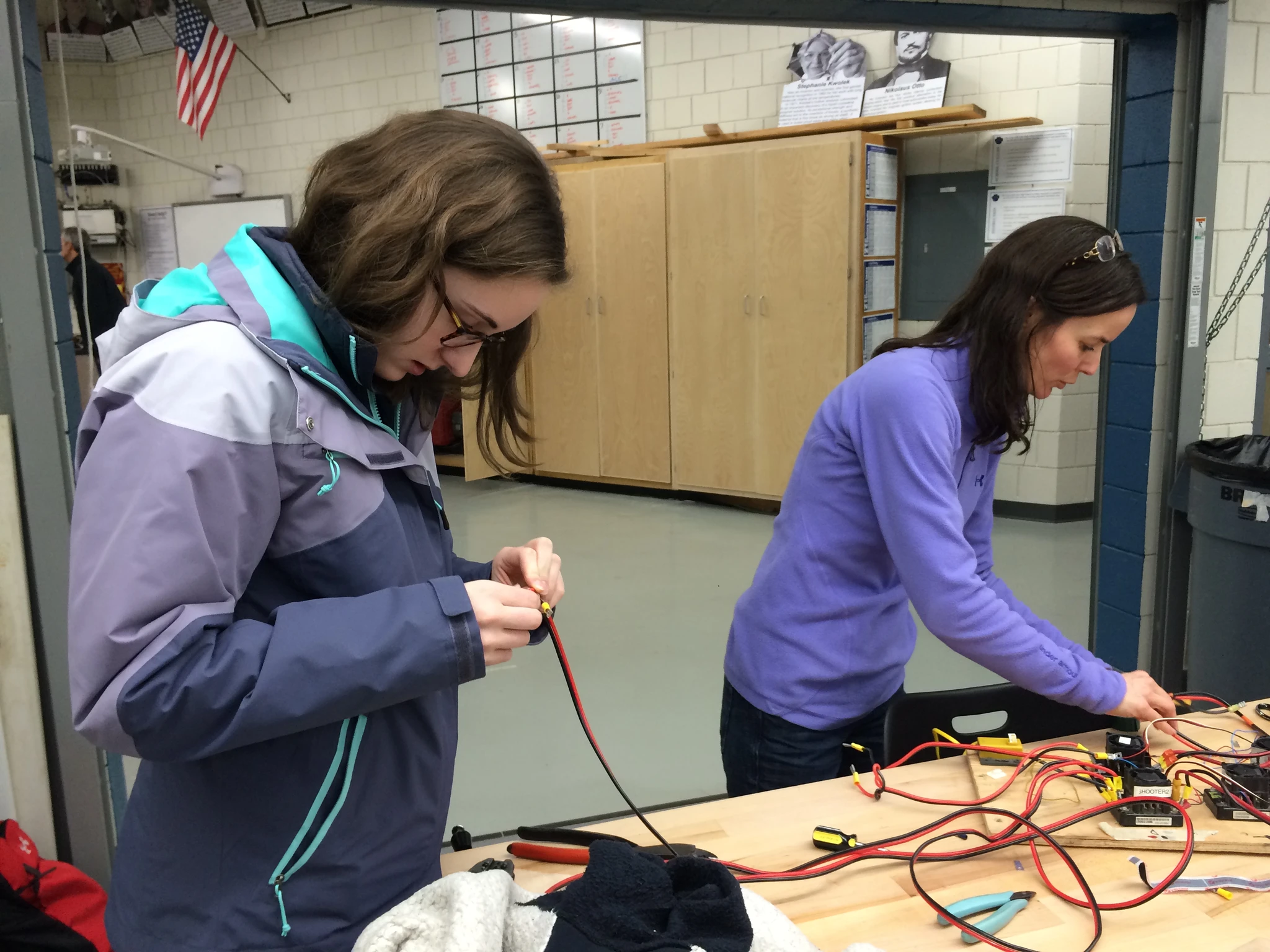 Alexis and Mrs DiCarlo hook up the motors to allow testing of the intake wheels