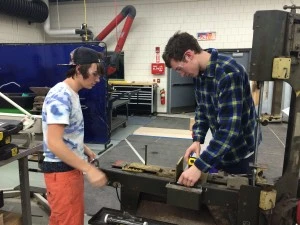 Justin and Liam cutting box for "real robot parts!"