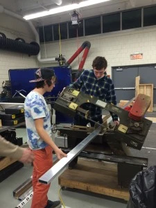Justin and Liam cutting box for "real robot parts!"