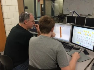 Hunter works with Mr Trudeau on Solidworks to design the exact placement of the lightening holes